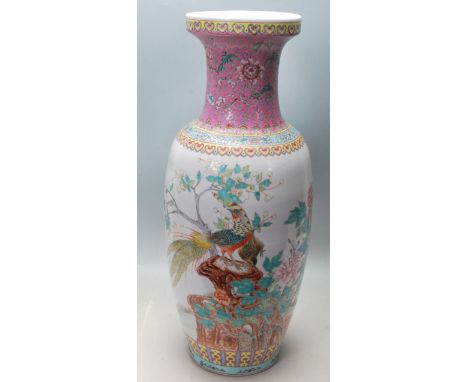 A large 20th century Chinese porcelain floor standing vase having hand painted Chinese motifs, peacocks and flowers. Unmarked