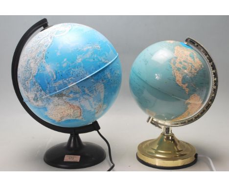 Two retro vintage desktop illuminating polychrome globes each being raised on a circular plinth bases. Measures 32 cm tall.