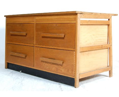 A good mid 20th Century retro vintage industrial golden oak plan chest having a large rectangular writing table top with four