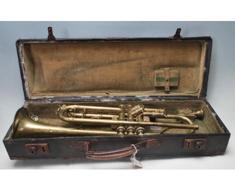 A vintage 20th century brass trumpet having mother of pearl keys and hard case. No makers marks. AF. Measures 17 cm high x 55