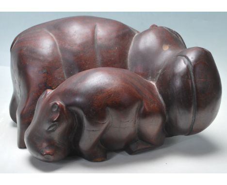 A vintage 20th century hand carved&nbsp;mahogany hippo /&nbsp;hippopotamus depicting a mother with a baby hippo. Measures 35 
