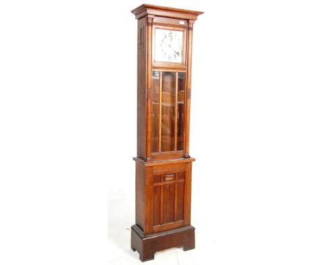 An early 20th century oak case grandfather clock. The clock having a silver dial with Arabic numerals to the chapter ring. Th