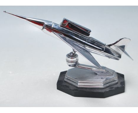 A retro vintage mid century chrome plated jet aeroplane table lighter by Gaia Sonic. The aeroplane is angled upwards and is s