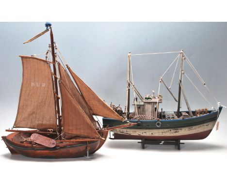 Two vintage late 20th century scratch built hand made toy sailing boats. The fishing trawler has a red white and green colour