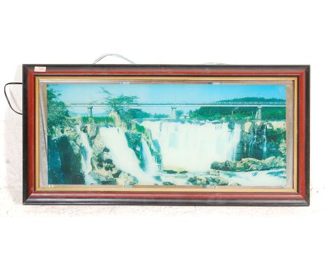 A vintage 20th century light up glass cased mirror print painting scene of a waterfall with railway bridge, likely from a Chi