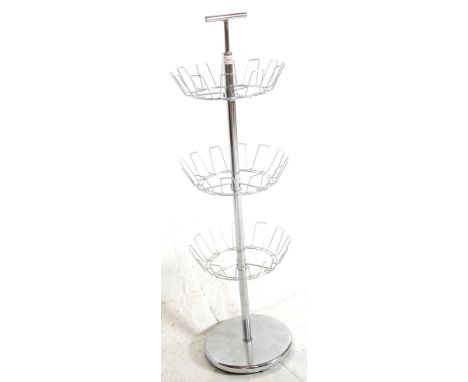 A vintage 20th century chrome floor standing shoe rack of &nbsp;cylindrical form with three wire revolving shelves, T handle 