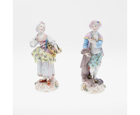 A pair of Meissen style figures, including a lady holding a basket of fruit, and a gent with a snake and fish around the base