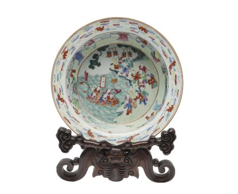 A large late 19thc basin, the centre painted with various children including some in a boat, with further figures around the 