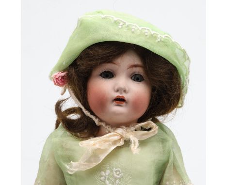 A bisque head doll with weighted blue eyes, open mouth and jointed composition body, with a mechanism which moves the head wh