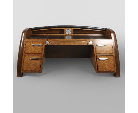 A large Louro Preto and Chestnut burl veneered Classic Car pedestal desk, the angled sides enclosing a leather inlaid 'hood' 