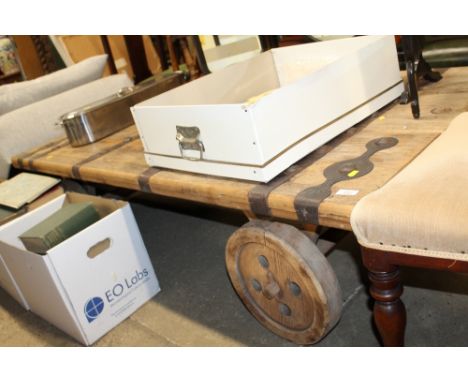 An unusual metal mounted coffee table in the form of a vintage cart