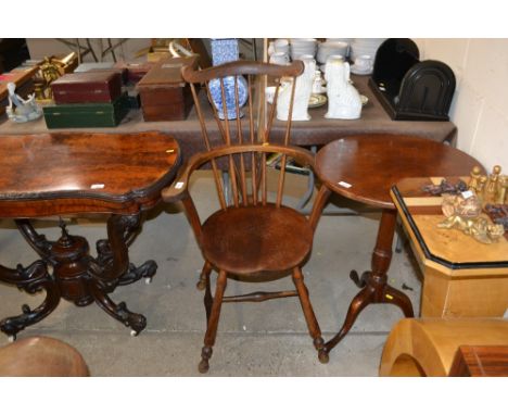 An antique elm seated Windsor type stick back elbow chair 