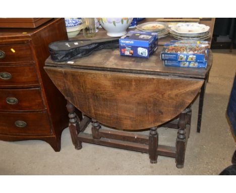 An antique oak gate leg dining table 