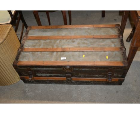 A vintage wooden and metal zinc lined trunk