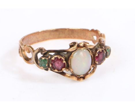 A yellow metal and opal ring, the head set with a oval opal with garnets and emeralds to the shoulders, weight 1.7 grams&nbsp