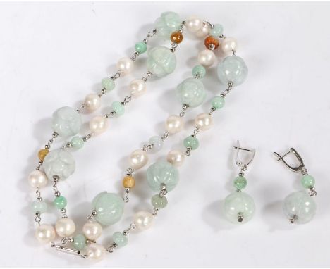 A carved jade necklace with intersecting pearls, the jade carved into flower heads, with a matching pair of earrings with sil