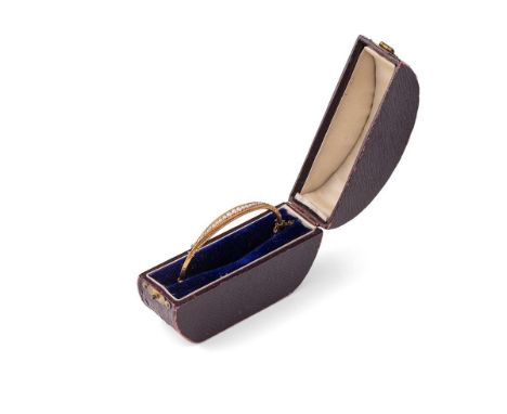 A yellow metal lady's bangle, tests as 9ct or better, set graduated seed pearls, in period fitted box, 4.0g, 64mm diameter.