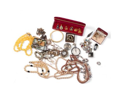 A silver charm bracelet with a large number of shield charms from various locations, mostly UK and Europe, with heart shaped 