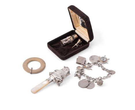 A group of silver comprising a silver cased small scent bottle and funnel, a silver charm bracelet with nine charms, includin
