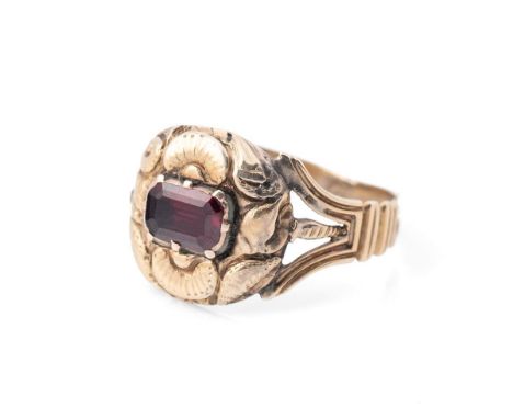 A 19th century mourning ring, tests as 9ct gold or better, inset with a garnet and monogram engraved verso, apparently unmark