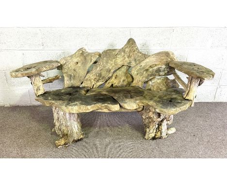 A rustic garden bench, formed from assorted sections of random tree rounds, with two arms, 155cm wide; also a wooden bird hou