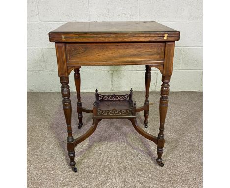 A late Victorian rosewood envelope card table, circa 1890, with rotating and fold-over top, over a single drawer, with decora