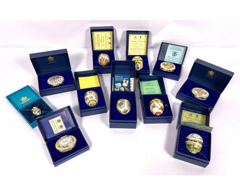 A large group of assorted Halcyon Days enamelled trinket boxes and Easter eggs, with original cases; including the 1990 Easte
