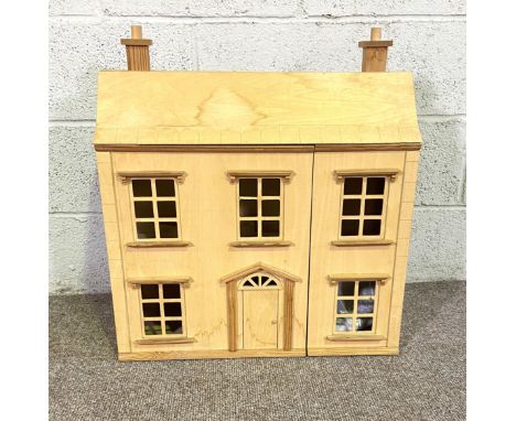 A vintage wood dolls house, in Classical Georgian style, opening to three floors. Available for occupation on Christmas Day 2