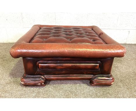 A small button upholstered 'leathered' footstool, including compartment base