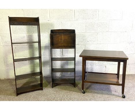 Two small narrow oak book stands, one with a moulded frieze and four shelves, 118cm high; also a wall shelf and folding card 