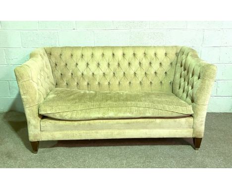 A button backed high backed sofa, with tapered feet and castors