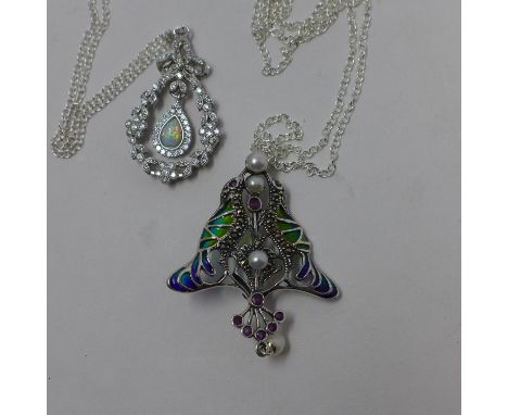 Two sterling silver pendants on silver chains: an Art Nouveau style example with plique a jour enamel, rubies and pearls, 5 x