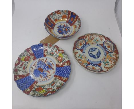 Two Japanese Imari plates, decorated with stylised flowers, Diameter 25cm; and cartouches of birds and flowers, Diameter 22cm