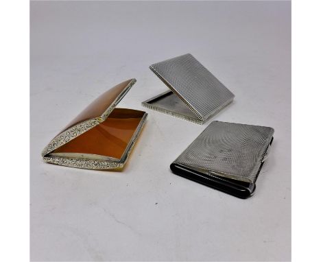A Continental silver compact, with makers marks and stamped 935, together with a silver engine turned card case, with makers 