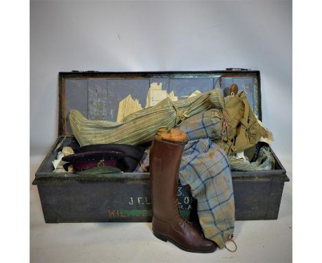 A late 19th/early 20th century metal trunk with contents including leather riding boots with wooden trees, an army uniform an