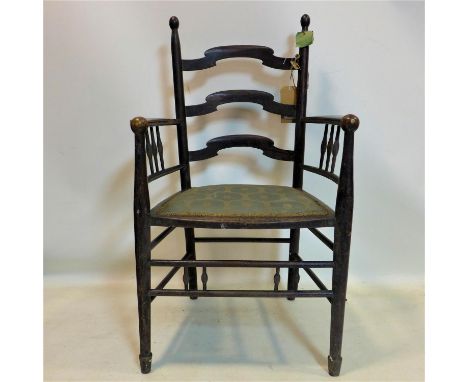 An Arts &amp; Crafts ebonized ladder-back armchair 
