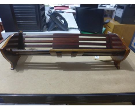 An inlaid mahogany sliding book trough, incised '774' to base, H.12 W.57 D.23cm (fully extended) 