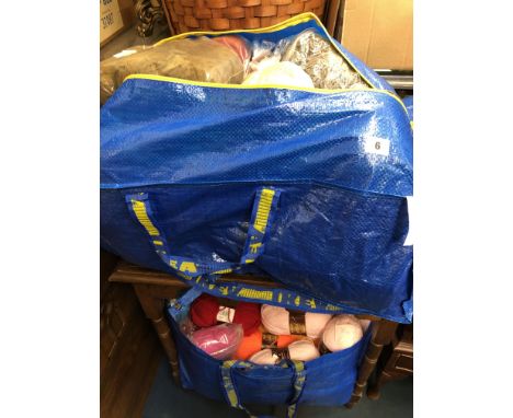 TWO HOLDALL BAGS OF CARPET THRUMS, KNITTING WOOLS, THROWS AND THRUMS