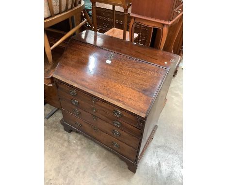 Georgian oak bureau with fitted interior and four long graduated drawers below on bracket feet, 83.5cm wide, 49cm deep, 95cm 
