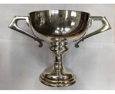 Silver plated two handled trophy cup, silver plated tea and coffee set with fluted decoration and other silver plated wares,