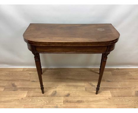 Regency mahogany and line inlaid D-shaped fold over card table, with green baize lined playing surface on ring turned tapered