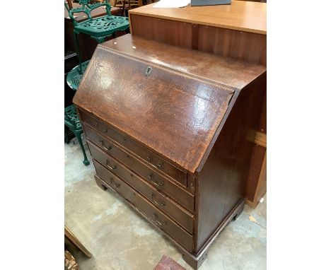 Georgian oak bureau with fitted interior and four long graduated drawers below on bracket feet, 99cm wide, 54cm deep, 109cm h