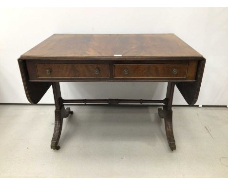 Late 19th century Georgian-style mahogany sofa table with twin flaps flanking two drawers, on splayed and reeded legs termina