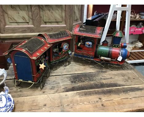 A large Christmas-themed tinplate train, including an engine and two carriages