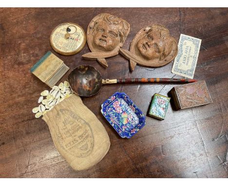 Group of mixed items to include enamel dish and matchbox cover, pair of carved cherub mounts, miniature cowrie shells, 18th c