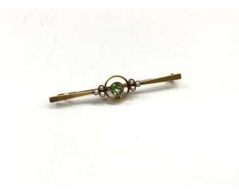 Edwardian 15ct gold peridot and seed pearl bar broochCondition report: Stamped 15ct and weighs 4.2 grams 