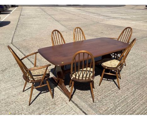 Ercol dining table and six chairs, comprising four standards and two carvers