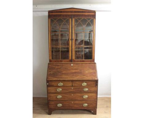 George IV mahogany bureau bookcase, the associated upper section enclosed by astragal glazed doors, the base with fitted bure
