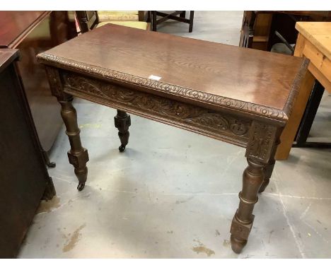 Edwardian carved oak rectangular card table with fold-over top, on carved legs