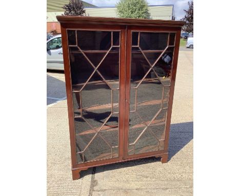 Good quality mahogany display cabinet with shelved interior enclosed by two astragal glazed doors on bracket feet, 126cm wide